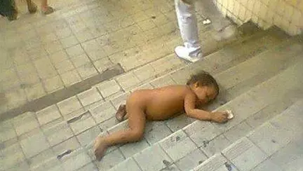 Imagini socante: un bebelus doarme dezbracat pe niste scari aglomerate si toata lumea il ignora
