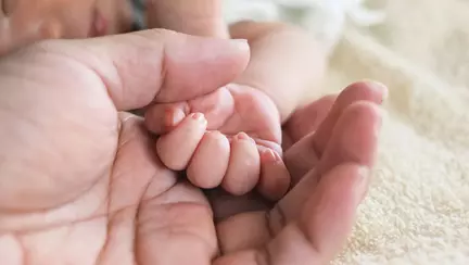 O poză cu un bebeluș care trage masca de pe fața doctorului a facut ocolul internetului