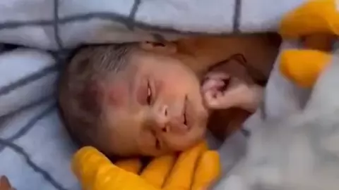 Imagini emoționante! Un bebeluș scos de sub dărâmături ținea în mânuță o șuviță din părul mamei