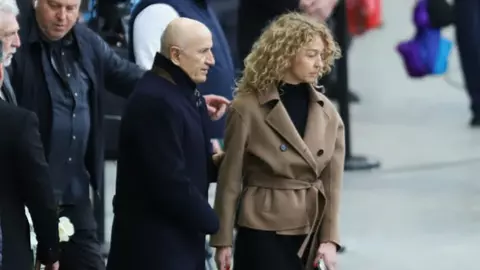 George Copos și soția Elena, în lacrimi la funeraliile lui Mircea Lucescu