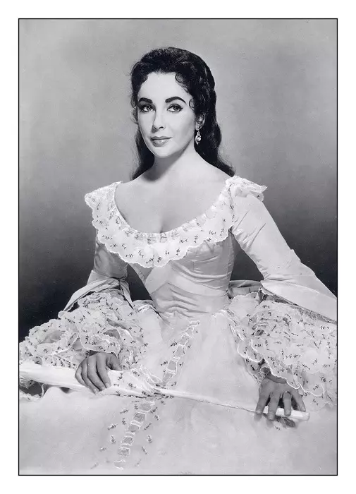 ELIZABETH TAYLOR Archive Hollywood Publicity Still Elizabeth Taylor (1932-2011), British actress, in period costume, holding a closed parasol, in a studio portrait publicity still for 'Raintree County', 1957 a romantic film drama, directed by Edward Dmytr