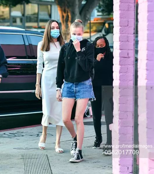 Angelina Jolie looks radiant in a white dress as she takes her two daughters Zahara and Vivienne on a shopping  trip on Melrose Ave in Los Angeles, CA