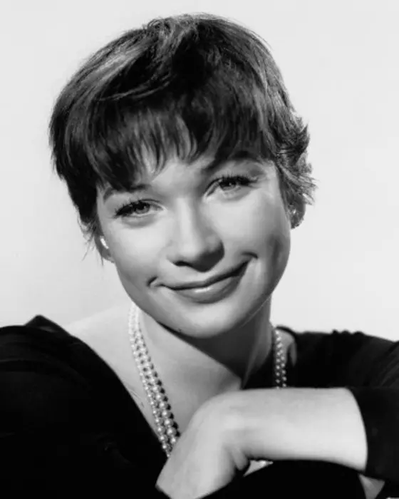A publicity photograph of actress Shirley MacLaine, taken for promotional purposes. The image features the star in a glamorous pose, capturing her charm and star power during her career peak.