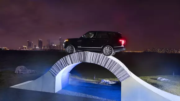 Un Range Rover traversează un pod din hârtie