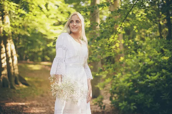61136875 - smiling bride in white dress in forest