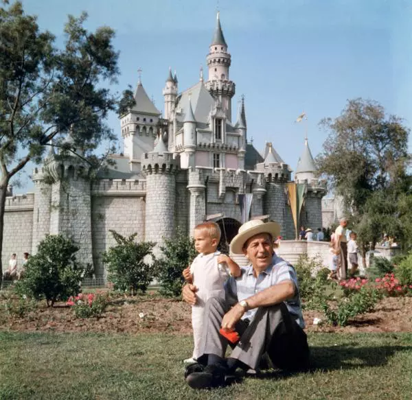 Walt Disney alături de nepotul lui în fața castelului din Regatul magic, Disneyland