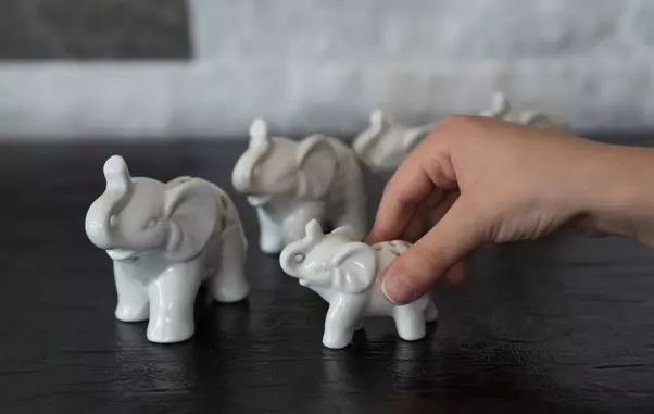Child,Playing,With,Porcelain,Elephant,From,Childrens,Activities.