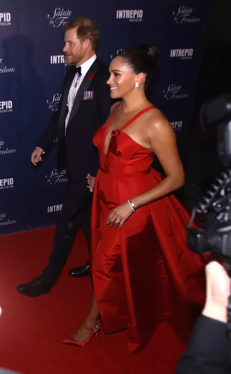 Prince Harry and Meghan Markle smile and laugh with veterans on the red carpet and are very animated as they attend a gala on eve of Veteran's Day in NYC