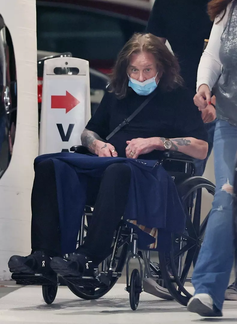 *EXCLUSIVE* Ozzy Osbourne leaves an office building being pushed in a wheelchair with two assistants as the Prince of Darkness looks frail in Los Angeles