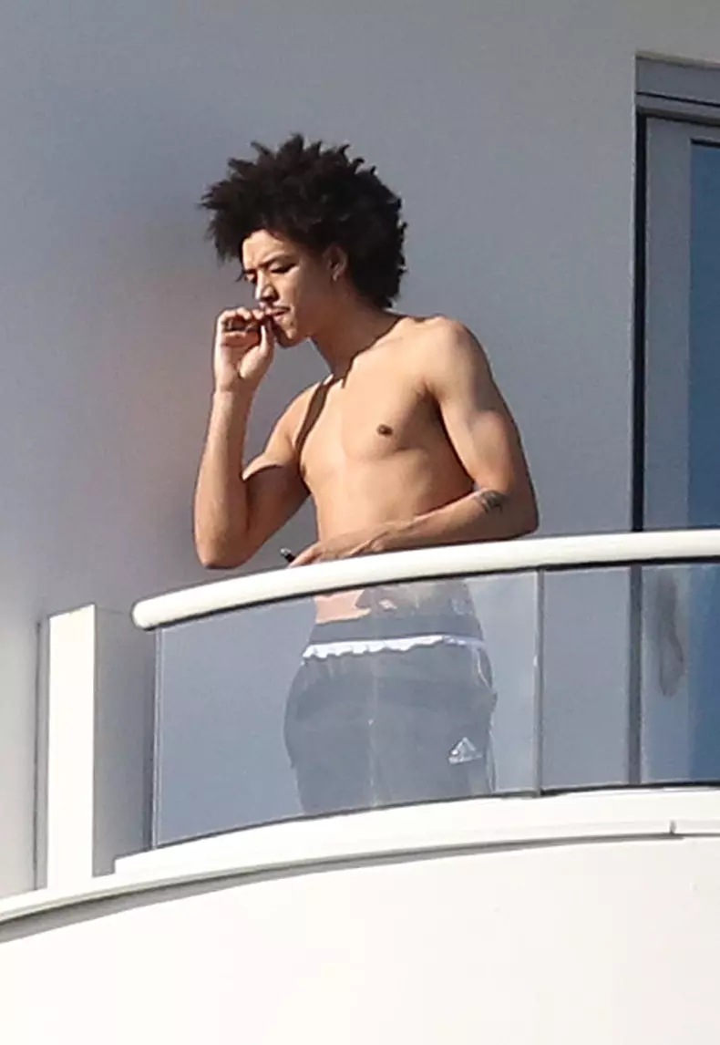 Madonna's rumored boyfriend, 26 year old dancer Ahlamalik Williams, rolls and smokes his own cigarette on their balcony in Miami