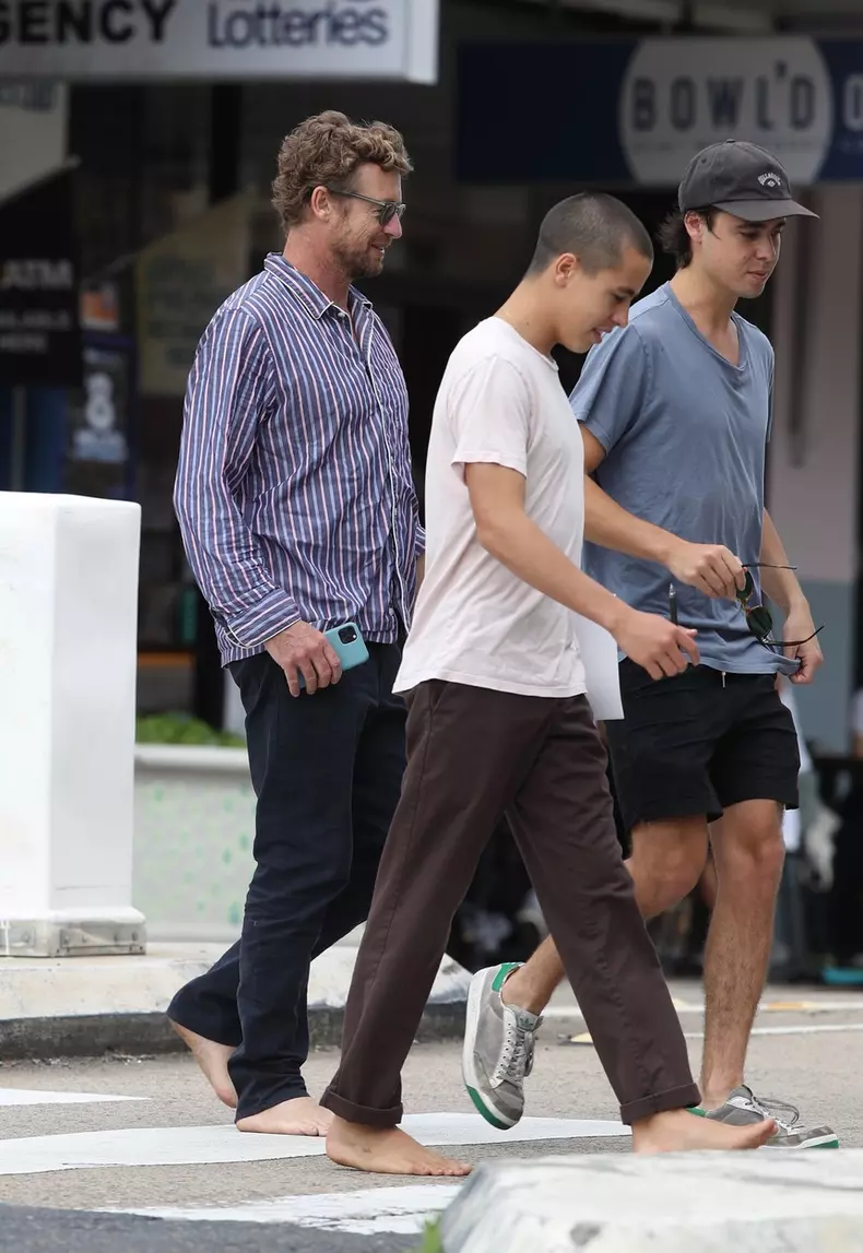 *EXCLUSIVE* Peace!  A relaxed and barefoot Simon Baker is pictured having breakfast with his son in Sydney.