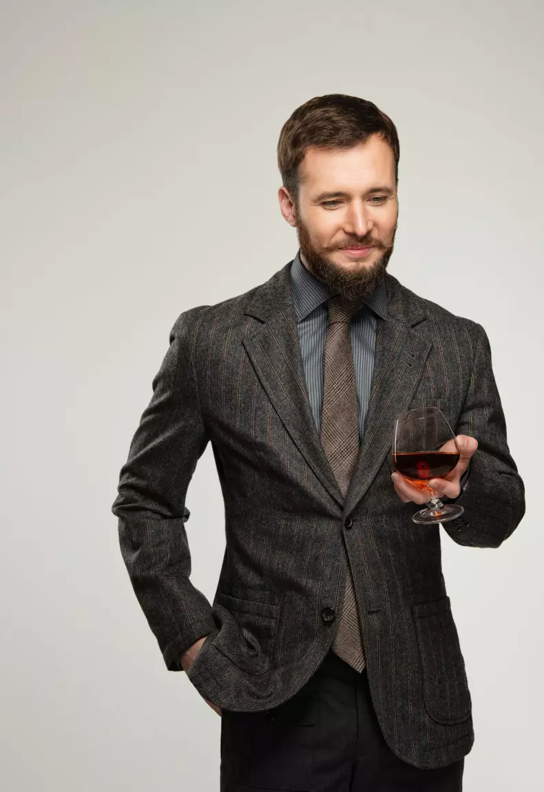Handsome,Well-dressed,Man,In,Jacket,With,Glass,Of,Beverage