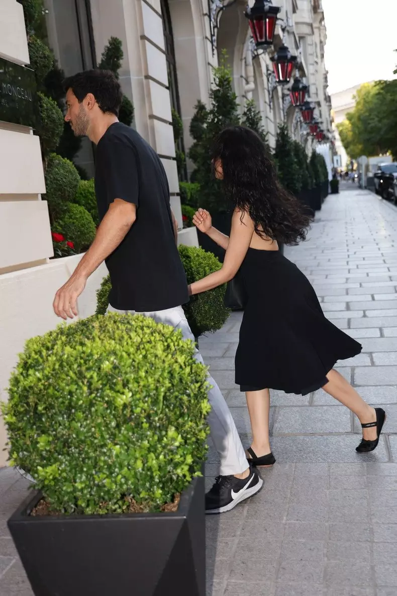 Camila Cabello and Henry Junior Chalhoub duck for cover during Paris walk
