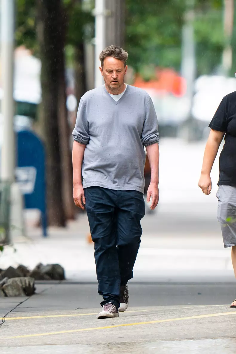 EXCLUSIVE: *PREMIUM EXC* Matthew Perry smokes while out for a stroll with a friend in the rain in New York City