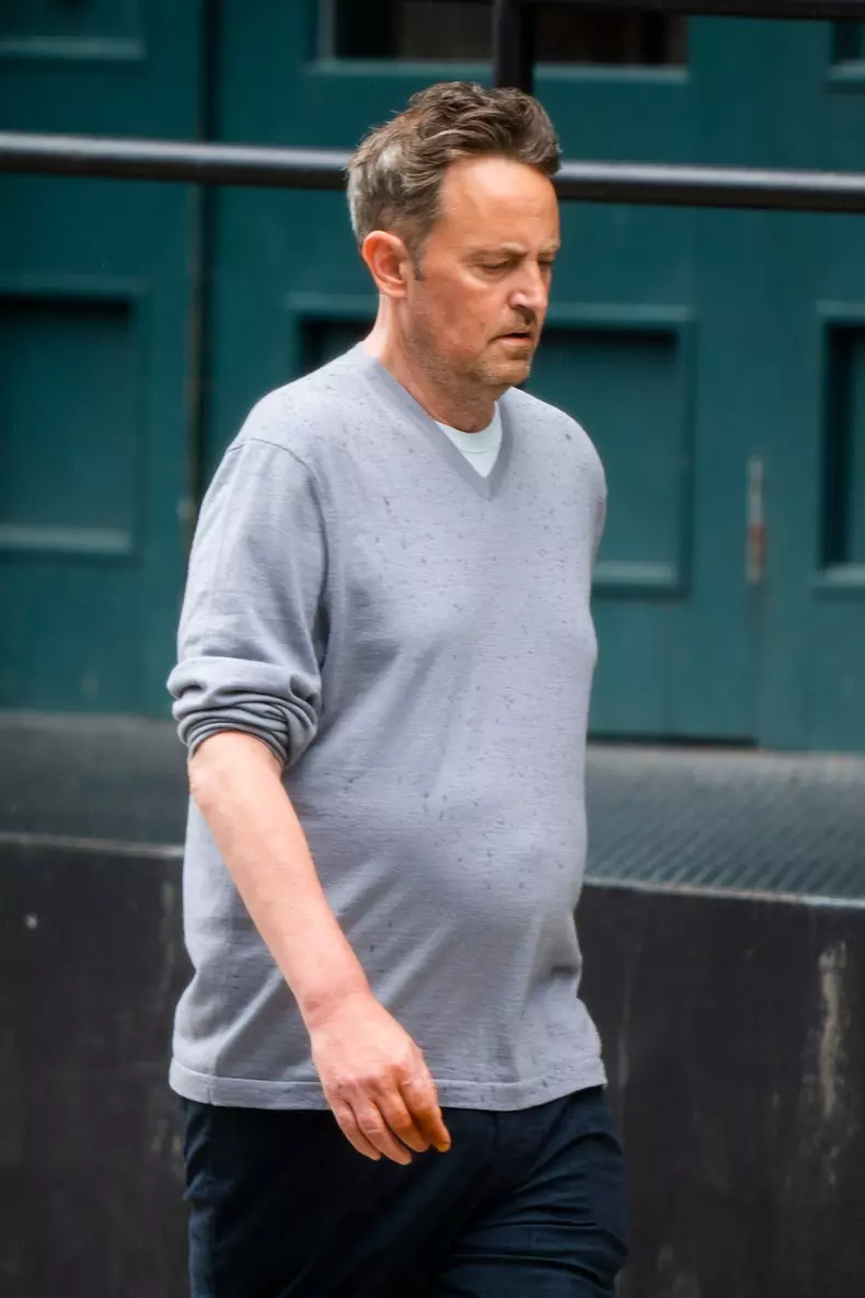 EXCLUSIVE: *PREMIUM EXC* Matthew Perry smokes while out for a stroll with a friend in the rain in New York City