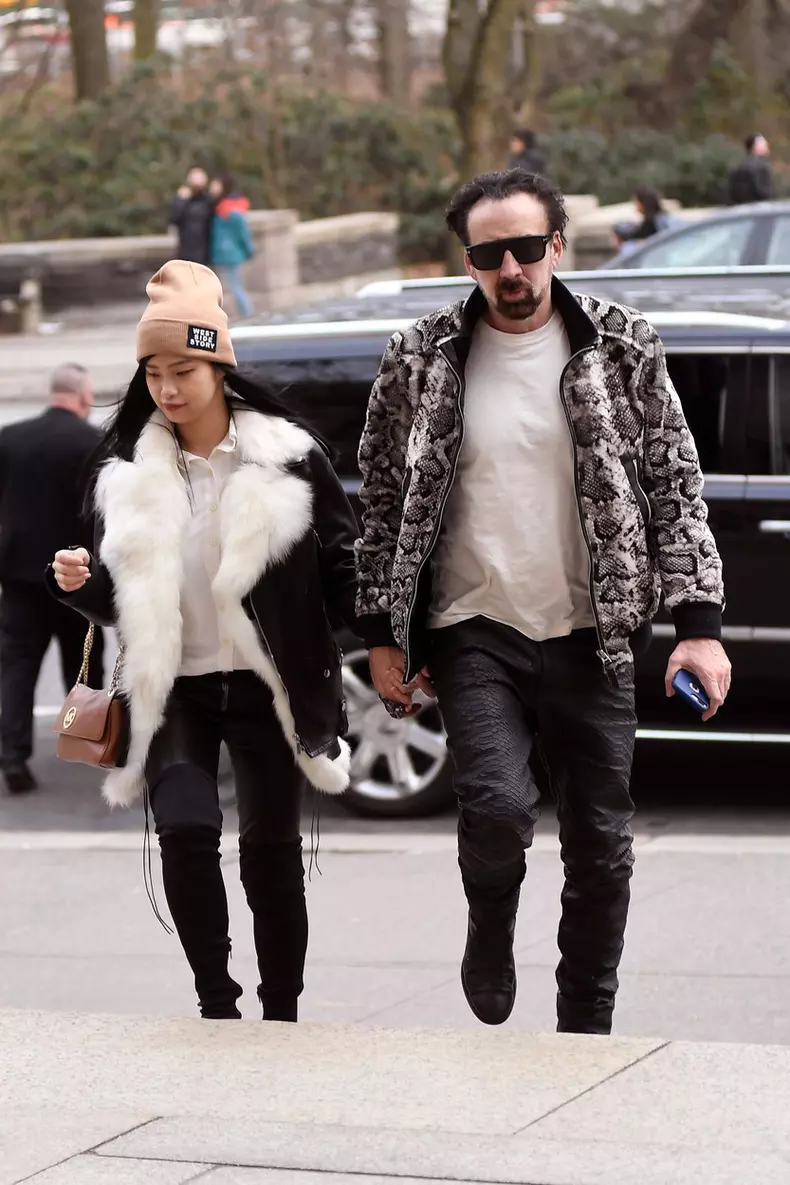 Nicolas Cage and his girlfriend matching black leather pants while going insid THE American Museum of Natural History
