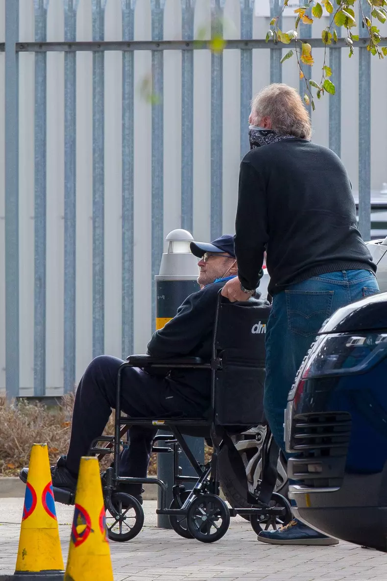 EXCLUSIVE: Phil Collins is helped into a wheelchair amid his ongoing battle to evict ex-wife Orianne Cevey from his $32 million Miami mansion