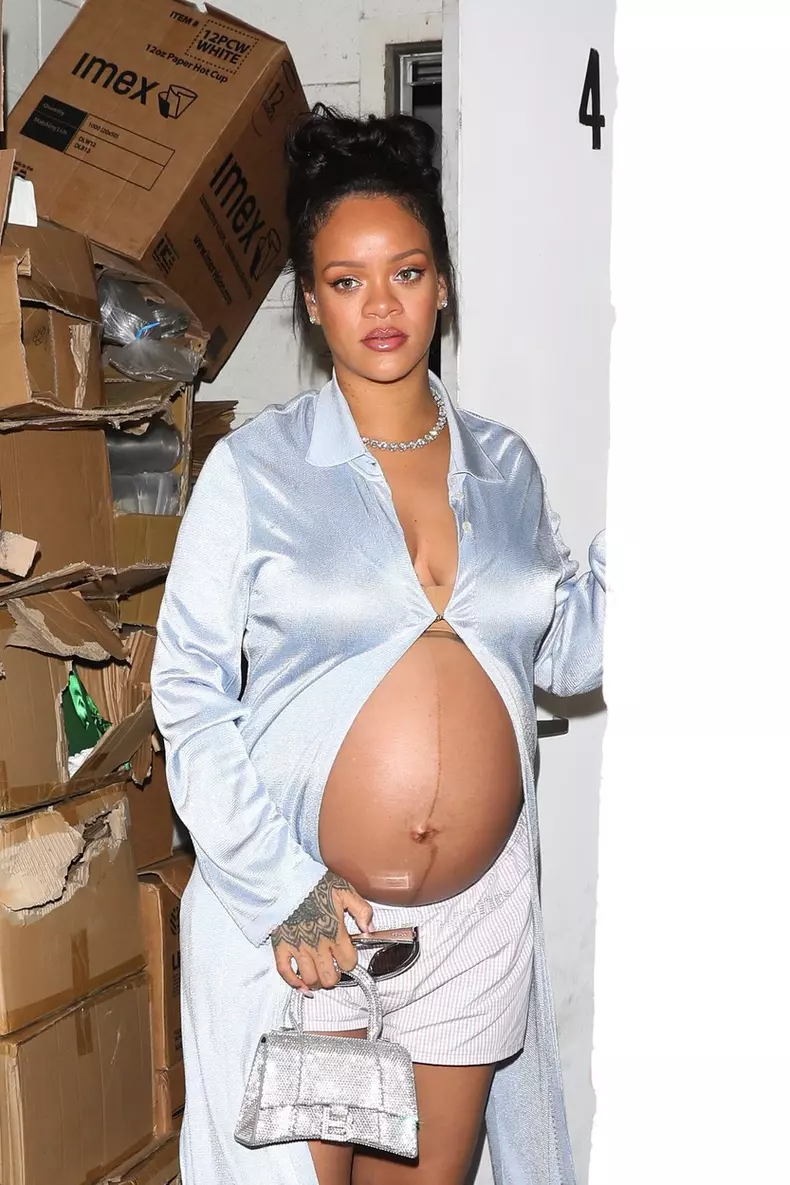 Rihanna shows off her burgeoning baby bump while out for dinner!
