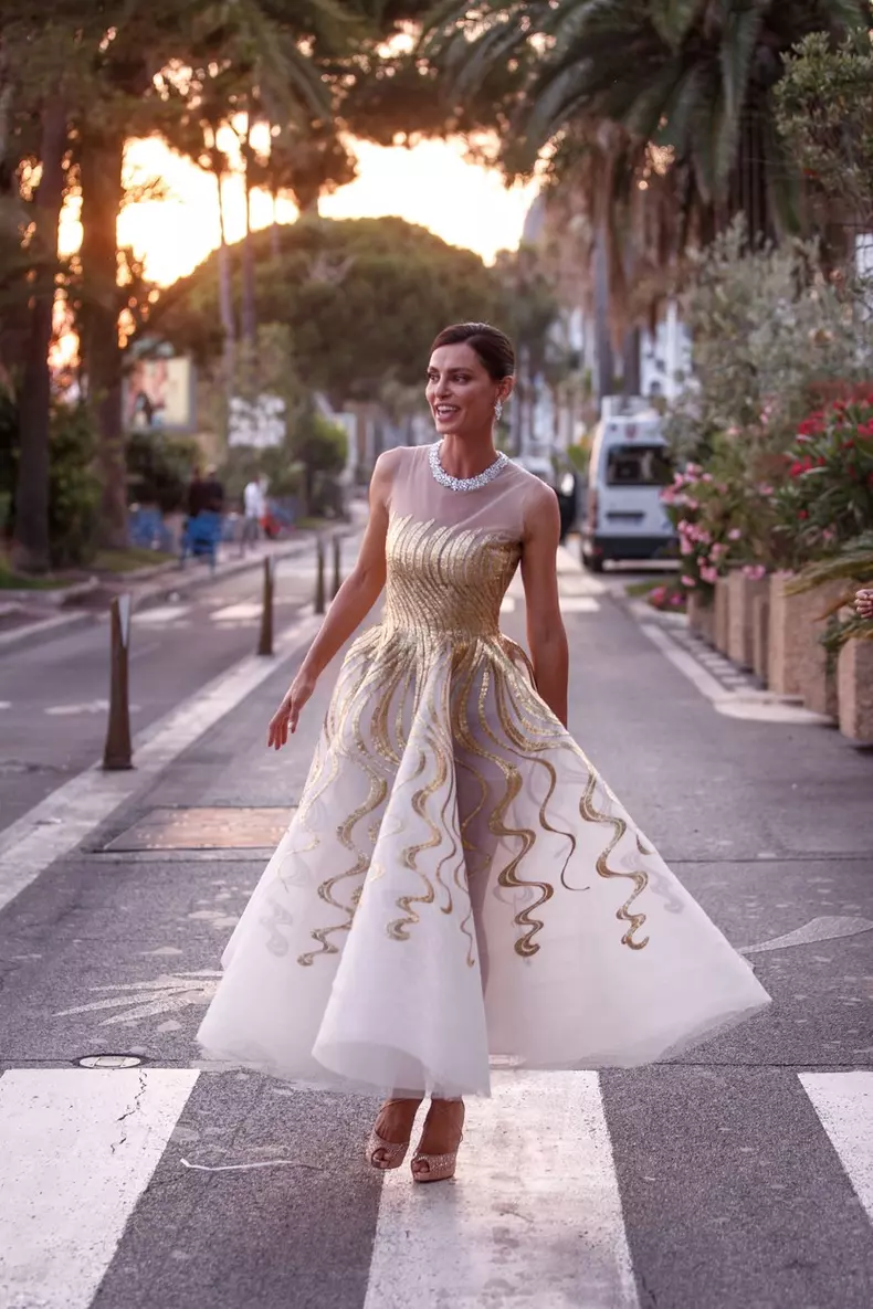Catrinel Menghia looks stunning in long ballgown dress and stylish jewellery on the way to the Chopard Dinner during the 74th Cannes Film Festival