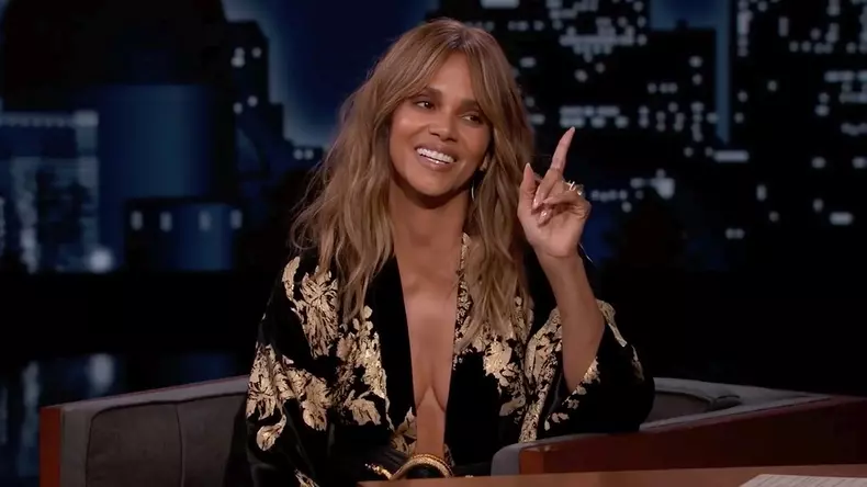 Halle Berry stuns in plunging black and gold dress for TV chat to promote new MMA movie
