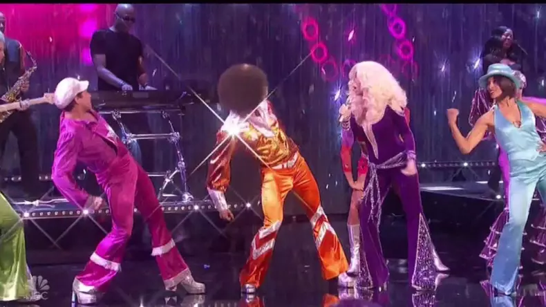 Cher rocks plunging purple jumpsuit as she performs the ABBA hit Waterloo on American's Got Talent finale