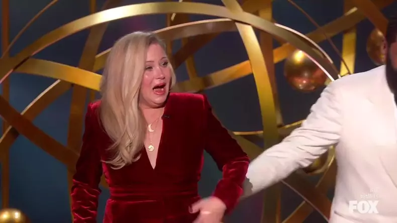Christina Applegate gets a standing ovation as she walks out on stage with a cane to present at the Emmy Awards