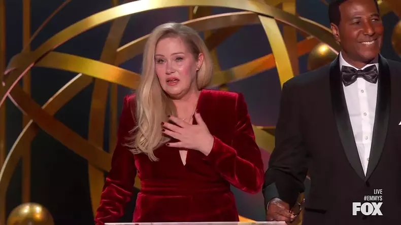 Christina Applegate gets a standing ovation as she walks out on stage with a cane to present at the Emmy Awards