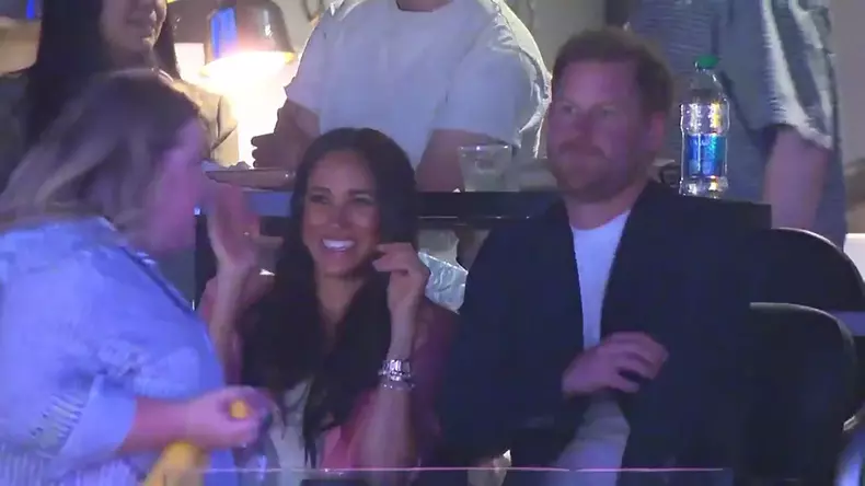 Prince Harry and Meghan Markle laughing during kiss cam at the NBA basketball playoff game in Los Angeles