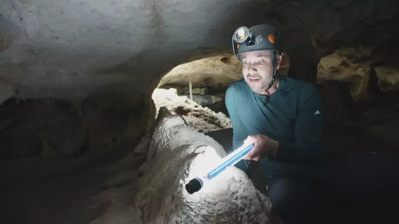 Paleoclimatologist Martin Medina examining Tzabnah cave rocks. (Pernel Media)