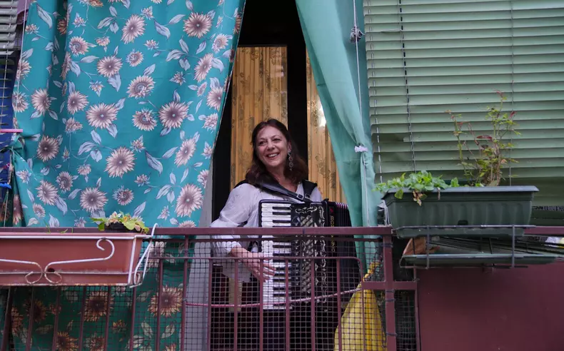 Italy: Coronavirus emergency. Italian people were told to avoid leaving home, - Stay Home- decree. Neighbors singing songs and playing music together from their windows to boost morale