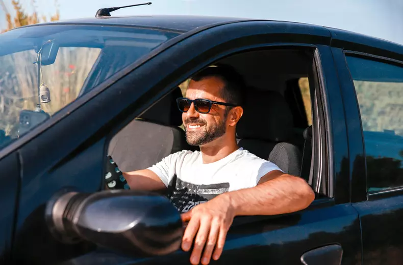 Handsome,Man,With,Sunglasses,Driving,A,Car,On,His,Road
