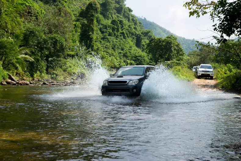 Car,4+4,drive,To,Cross,The,River,in,The,Forest,At,Thailand.