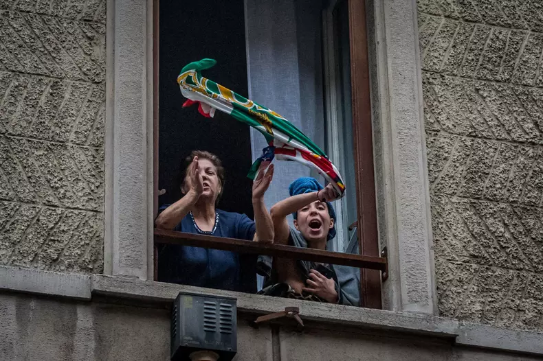 Italy: Coronavirus emergency. Italian people were told to avoid leaving home, - Stay Home- decree. Neighbors singing songs and playing music together from their windows to boost morale / Milan