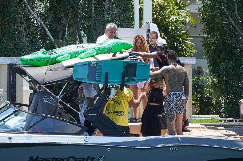 Shakira enjoys a barefoot trip with a boatload of male pals including F1 star Lewis Hamilton Miami as rumors swirl over possible Tom Cruise romance.
