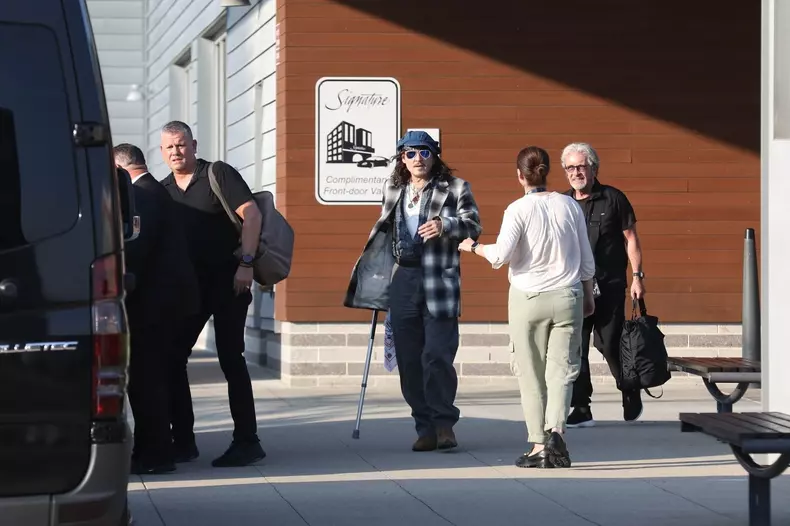 *EXCLUSIVE* Johnny Depp uses a cane while arriving in Boston for his Hollywood Vampires show after being forced to reschedule due to ankle fracture.