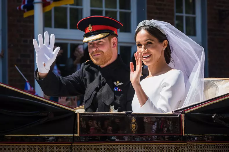 Windsor, UK, 19 May 2018. Prince Harry and his bride Meghan Markle ride around the streets of Windsor in a state Landau greeted by huge crowds cheering and waving flags following their wedding at St Georges Chapel. Before heading back to Windsor castle fo