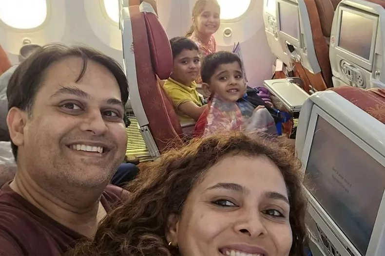 Prateek Joshi poses for a selfie with his family during Air India flight.