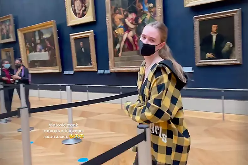 Luiza Rozova (also known as Elizaveta Krivonogikh), now 21, pictured in the Louvre in 2021. The writing in Russian reads: "@nicole.msnk became a blogger"