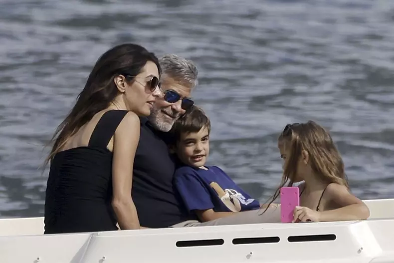 George Clooney and Amal Clooney, accompanied by their sleepy kids Ella and Alexander, embark on a picturesque boat trip in Como