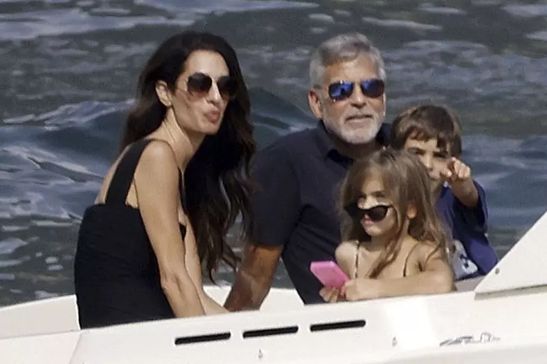 George Clooney and Amal Clooney, accompanied by their sleepy kids Ella and Alexander, embark on a picturesque boat trip in Como