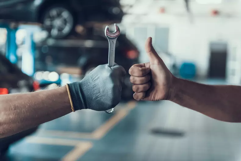 Close-up,Thumb,Up,And,Mechanics,Hand,With,Tool.,Automobile,Master