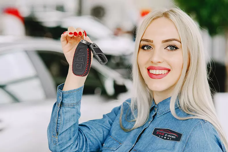 Stylish and elegant woman in a car salon