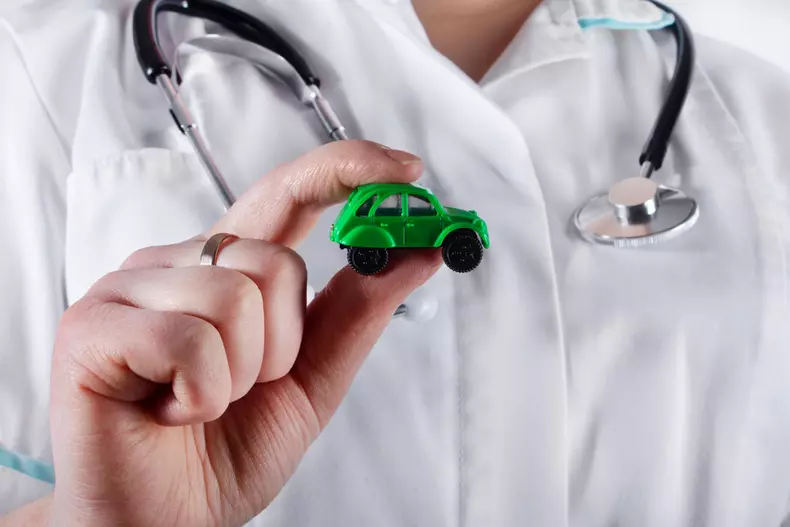 A,Doctor,Woman,Holding,A,Toy,Car,,Close,Up.