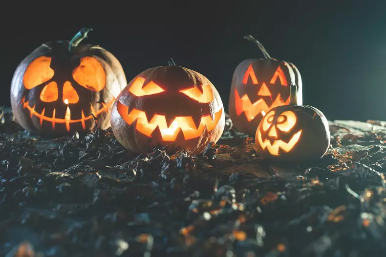 Halloween pumpkins at wood background.