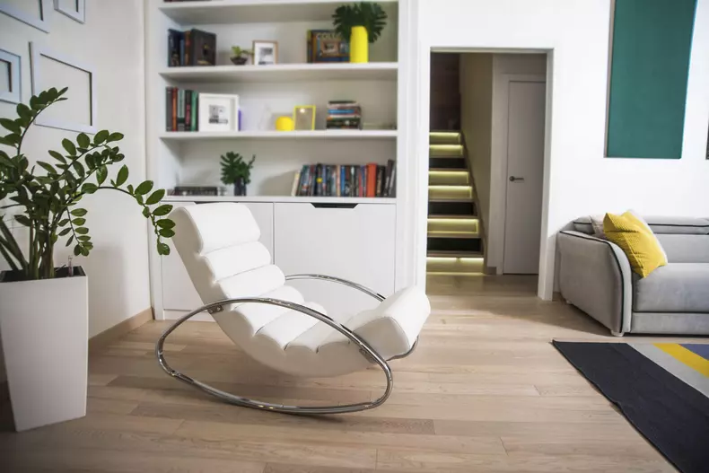 Modern,Metal,And,White,Leather,Rocking,Chair,Stand,Near,Green