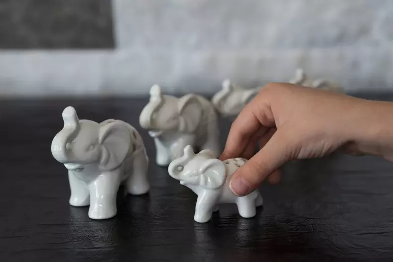 Child,Playing,With,Porcelain,Elephant,From,Children’s,Activities.