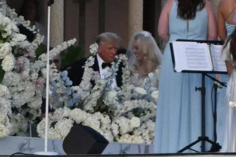 Former US President Donald Trump walks his daughter Tiffany Trump down the isle during her wedding at Mar A Lago