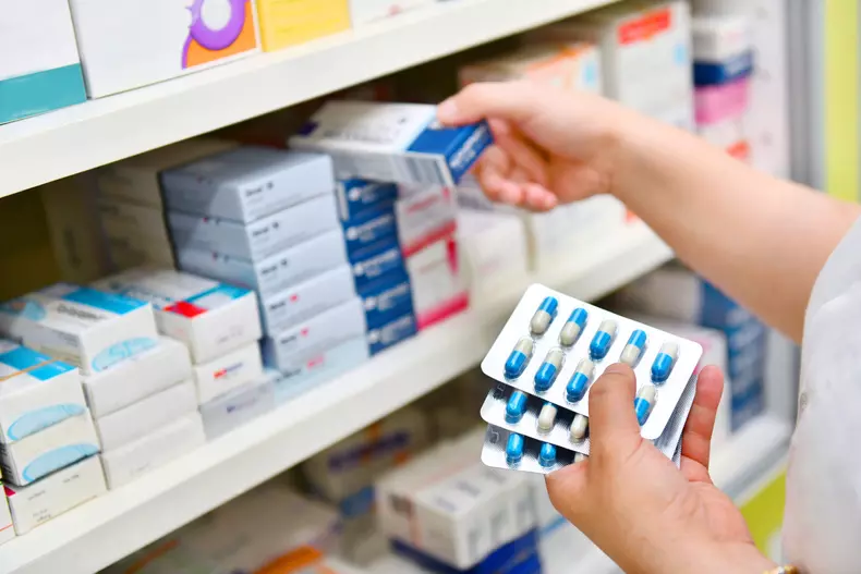 Pharmacist,Holding,Medicine,Box,And,Capsule,Pack,In,Pharmacy,Drugstore.