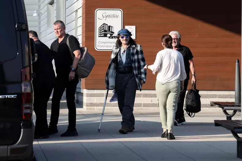 *EXCLUSIVE* Johnny Depp uses a cane while arriving in Boston for his Hollywood Vampires show after being forced to reschedule due to ankle fracture.