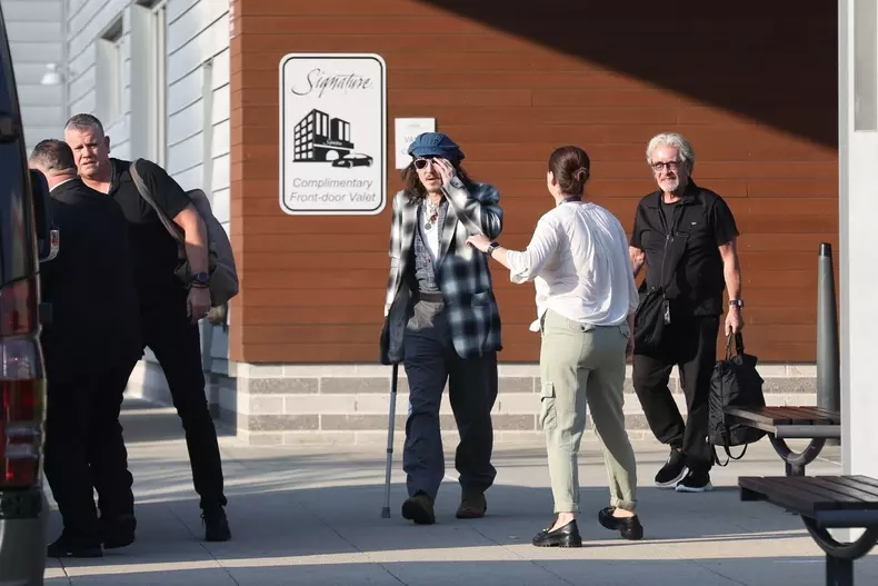 *EXCLUSIVE* Johnny Depp uses a cane while arriving in Boston for his Hollywood Vampires show after being forced to reschedule due to ankle fracture.